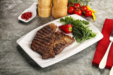 Grilled chuck roll steak with arugula