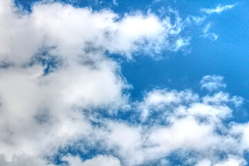 Clouds against a vivid blue sky on a summers day in June in the UK