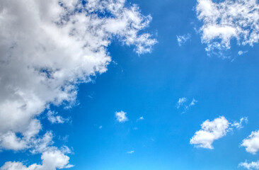 Clouds against a vivid blue sky on a summers day in June in the UK