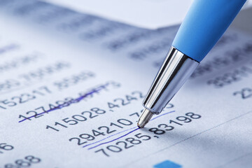 Accounting document with pen, money, coins and checking financial chart. Concept of banking, financial report and financial audit.