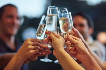 Bubbles, hands and toast with friends outdoor for celebration or social gathering together. Alcohol glass, champagne and cheers with group of people in backyard for milestone or new years for fun