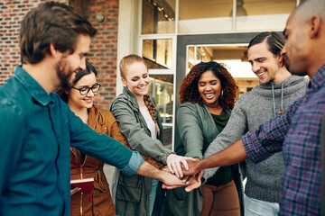Obraz premium Smile, group and students with hands stack for support at university, agreement and synergy of studying goal. Diversity, happy and people with team building, trust and learning for knowledge growth
