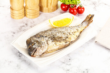 Baked Dorado fish served lemon