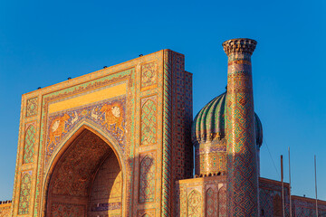 Sherdor Madrassah on Registan Square at sunset.
