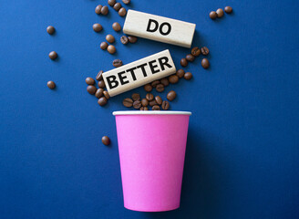 Do better symbol. Wooden blocks with words Do better. Beautiful deep blue background with coffee...