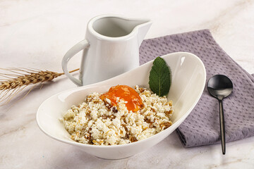 Curd with granola and orange jam