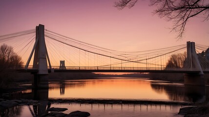 Obraz premium Suspension bridge captured during sunset. The bridge has a modern design with tall, white towers and cables extending from the top to the sides.
