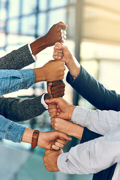 Business people, hands and fist stack with teamwork for employee solidarity, inclusion and equality in workplace. Diversity group, pile and collaboration for staff support, synergy and cooperation