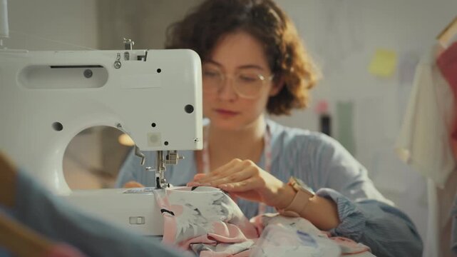 Sewing. A stylish fashionista creates sketches and develops patterns for clothes in a sewing workshop. A seamstress sews clothes to a personal order, supports fashion trends and styles, hobbies