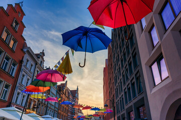 Colorful umbrellas on the street in Gdansk during the summer fair. Poland