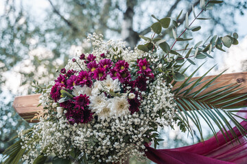 Beautiful flower arrangement with purple and white blooms for ceremony decor.
