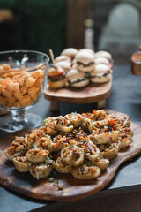 Stuffed potato bites with crispy toppings on a wooden platter