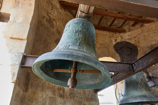 Bells in the bell tower of the Royal Clerecia of San Marcos in Salamanca, Castilla y Leon, Spain, with spanish shield