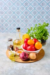 Prepared ingredients for cooking fast pickled tomatoes with onions on a gray concrete background. Harvesting, conservation. Tomatoes recipes