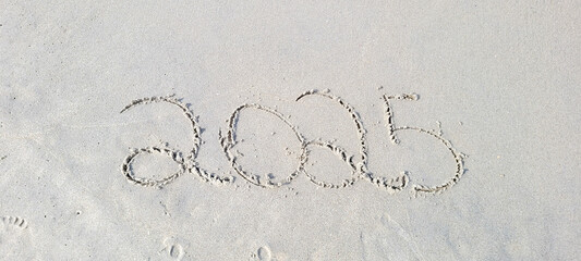 happy 2025 written in the sand of itamambuca ubatuba beach