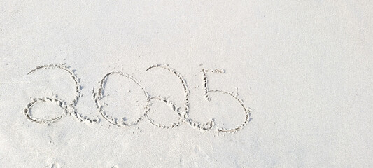 happy 2025 written in the sand of itamambuca ubatuba beach