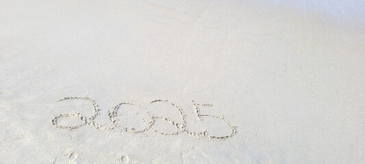 happy 2025 written in the sand of itamambuca ubatuba beach
