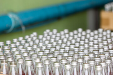 Juice in glass bottles in factory to fill with drink. Juice in glass bottles in a factory for the food industry, Row of bottling line for processing at beverages factory