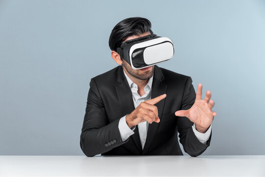 Smart businessman sitting while pointing and choosing data analysis by using technology innovation. Professional caucasian project manager using virtual reality glasses and VR goggles. Deviation.