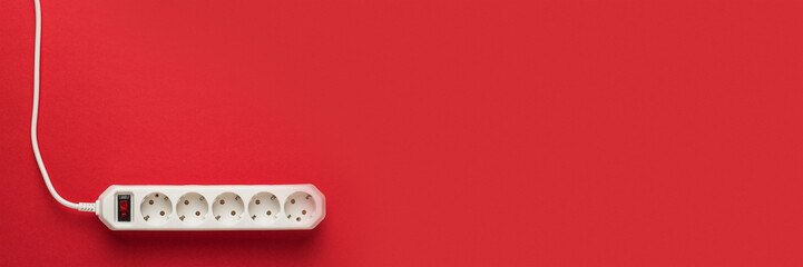 European 5-way power strip earthed on red background