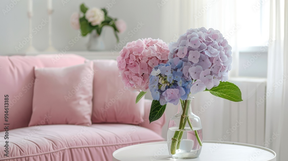 Canvas Prints Pastel hydrangeas in a vase on a table by a pink sofa in a white Scandinavian living room