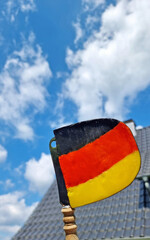 hand holding a flag from germany