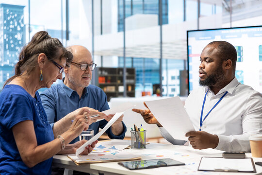 Elderly pair meeting with a financial expert to explore various pension options, establishing their income and investments. Mature couple discuss with advisor about retirement savings.