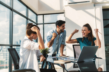 Group of happy businesspeople celebrate their successful project. Professional business team win and proud of their project at modern office. Successful teamwork, happy colleague, workplace. Tracery.