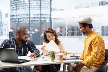 Business people collaborating with a real estate broker on office space relocation, reviewing...