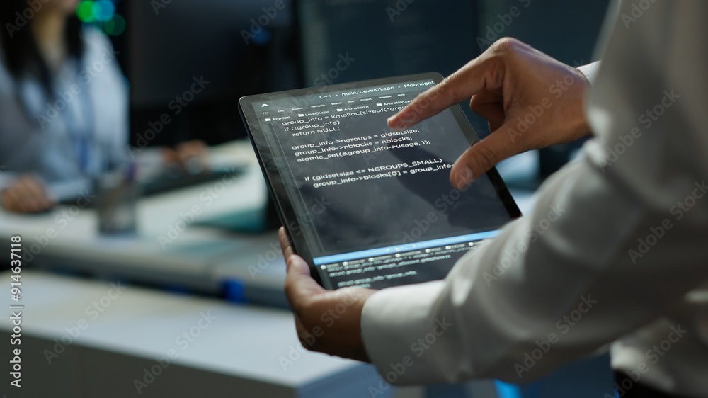 Poster programmer using device in data center, managing servers, operating systems. close up of specialist 