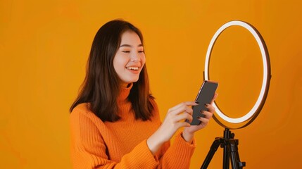 Smiling Woman Recording a Video with a Phone and Ring Light
