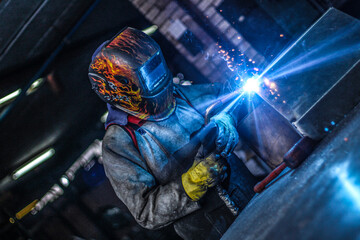 people working on welding in the factory