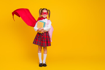Full body photo of small schoolchild superhero costume uniform book empty space isolated on yellow color background