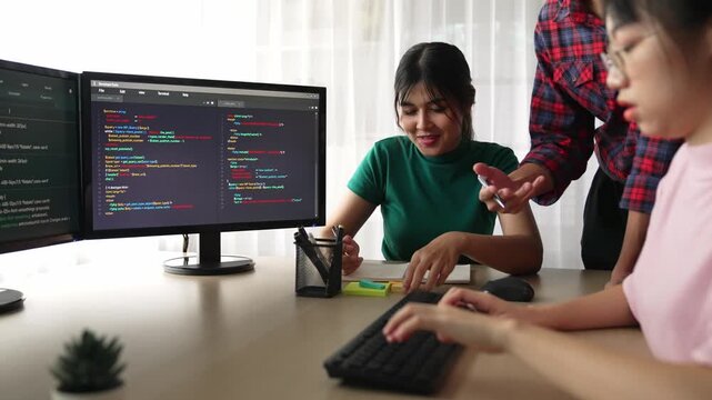 Back end software developer engineer for computer programming working together on debugging writing computing code, solving complex algorithms display on monitor in office. Burgeoning