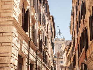 A picturesque view of narrow streets in the old town of Rome, italy, showcasing historic architecture and traditional Italian buildings under the warm sunlight.