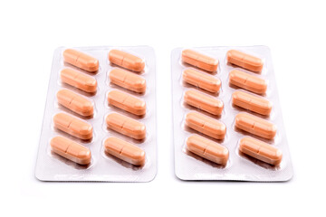 orange medical tablets in a blister pack