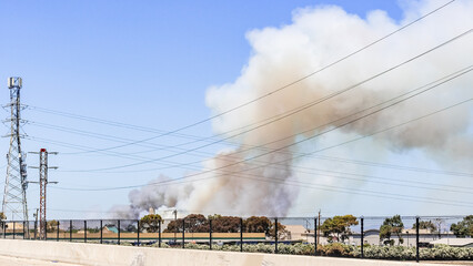 Smoke cloud rising from a brush wildfire burning in East San Francisco Bay Area, California