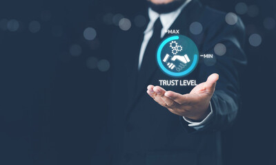 Fototapeta premium Trusted partner. Trustworthy collaboration, company or contract. Confidence to work together. Businessman turning knob to highest trust levels. Build trust in business and finance relationships.