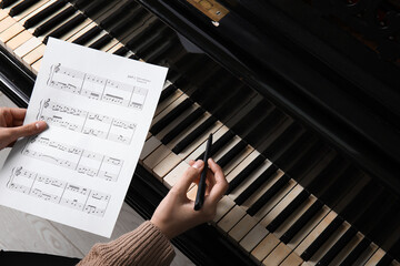 Young woman composing music with piano © Pixel-Shot
