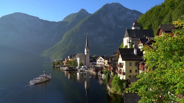 Hallstatt Village Ferry Pulling Up to Dock 4K UHD. The passenger ferry arrives at Hallstatt village on Hallstatter Lake in the Austrian Alps in the region of Salzkammergut, Austria. 4K, UHD.
