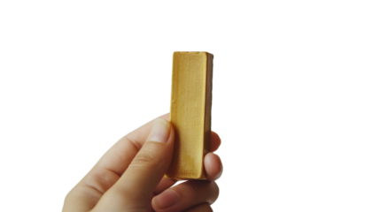 Hand holding gold bar on transparent background