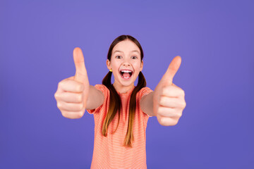Photo portrait of cute little girl thumb up approve dressed stylish red clothes isolated on violet...