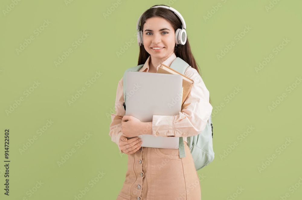 Sticker Female student in headphones with laptop on green background