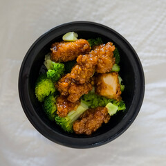 Bowl of general tsos chicken and broccoli