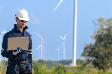 engineers working in fieldwork outdoor. Workers walking and inspect construction and machine around project site. Wind turbine electrical of clean resource enerdy and environment sustainable.