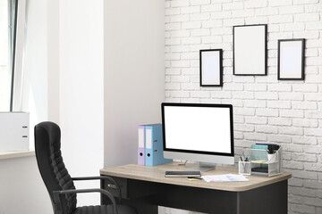 Workplace with modern computer, stationery and folders in stylish office