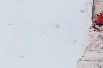 White plaster wall with natural defects. Fragment of the grunge surface. Natural cracked cement on...