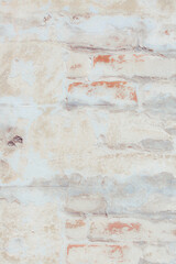 Old grungy red brick wall. Free space for an inscription. Fragment of a wall with bumps and peeling paint.