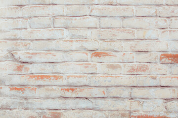 Old grungy red brick wall. Free space for an inscription. Fragment of a wall with bumps and peeling paint.