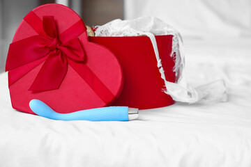 Vibrator with gift box on bed, closeup